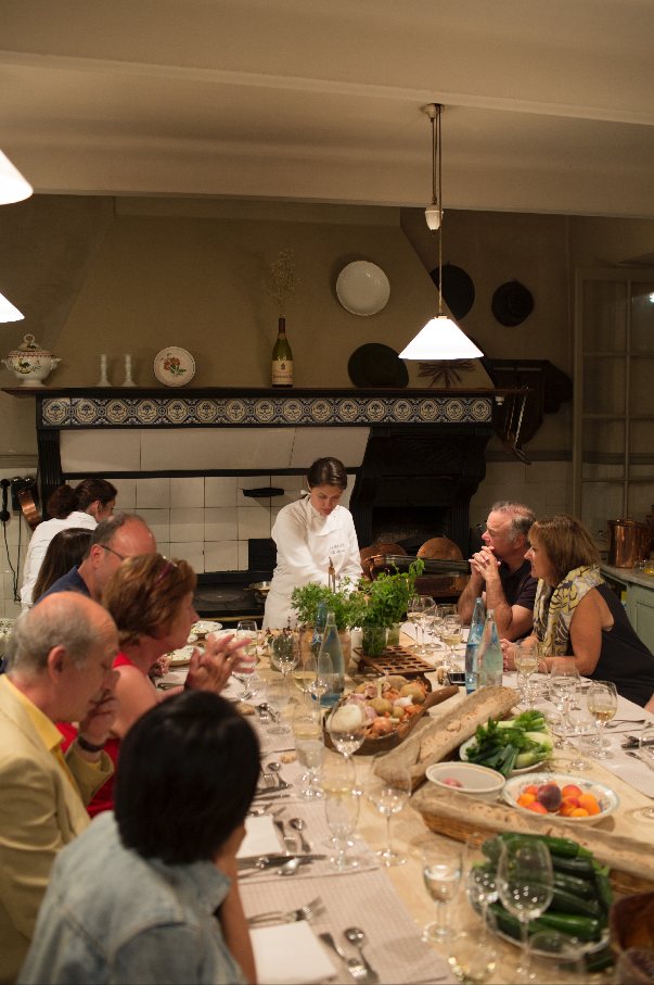 Guests enjoying a gourmet meal at a beautifully set dining table.