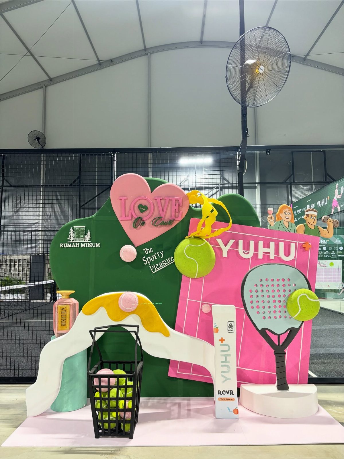 Large colorful tennis and pickleball themed party decorations with rackets and balls.