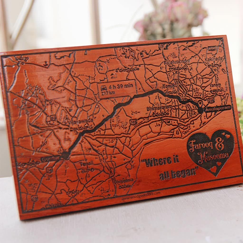Engraved wooden map plaque with etched text and a heart design.