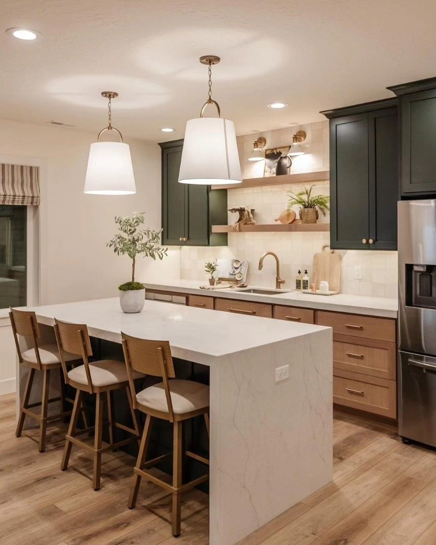 17 Basement Kitchenette Ideas That Maximize Every Square Foot 4 Modern kitchen with dark green cabinets, white marble island, and wooden open shelving on a neutral wall.