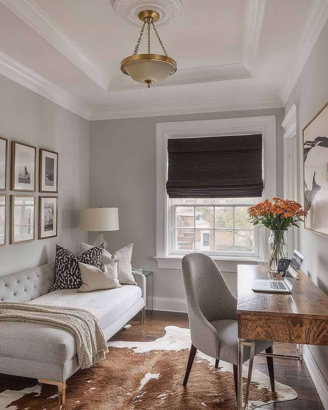 20 Bedroom Office Ideas for Small Spaces and Dual-Purpose Rooms 1 Wooden desk with a laptop and flowers placed directly beside a bright window.