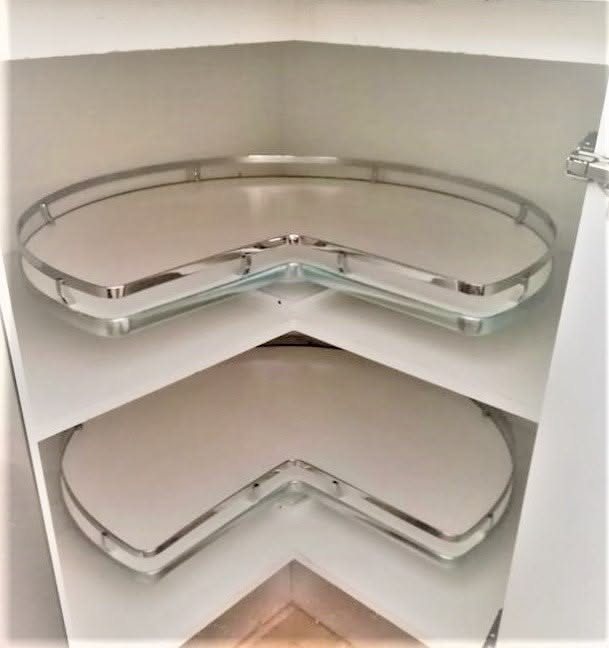 8 Corner Cabinet Ideas for Kitchens That Actually Work 1 Two white corner cabinet shelves featuring rotating clear glass trays with silver metal rims.