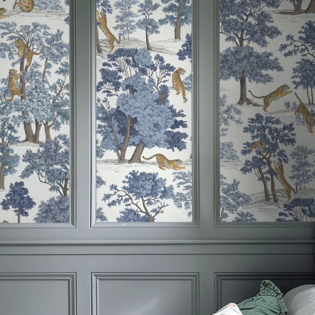 Blue and white tiger patterned wallpaper set inside grey decorative wall panelling.