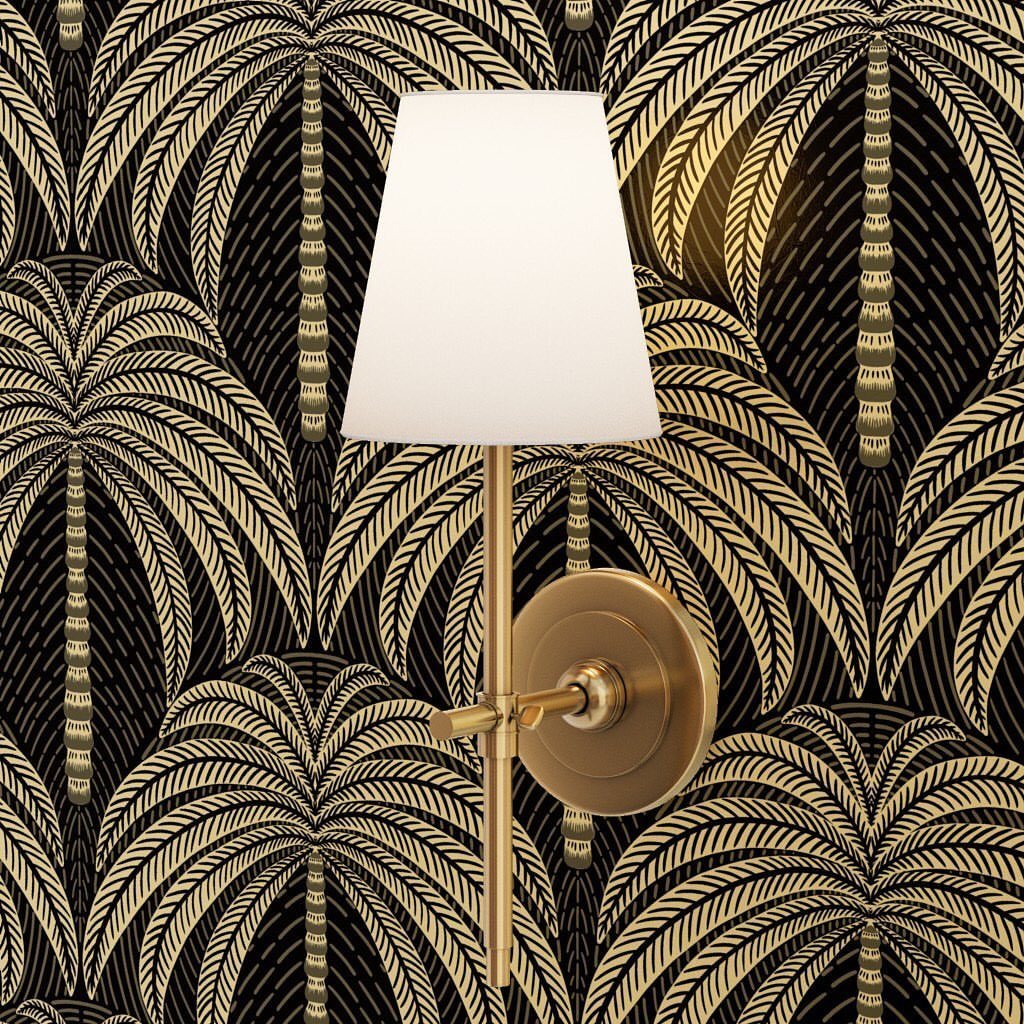 Gold palm tree patterned wallpaper with a metallic wall sconce and white lampshade.