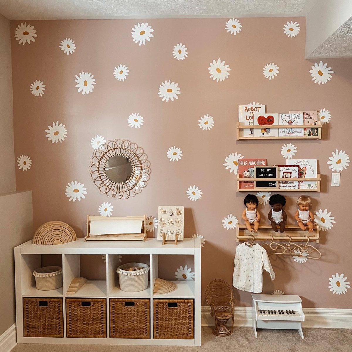 7 Playroom Wall Paint Ideas for Kids Who Need Space to Play 7 White daisy wall decals on a dusty rose wall in a child's playroom.
