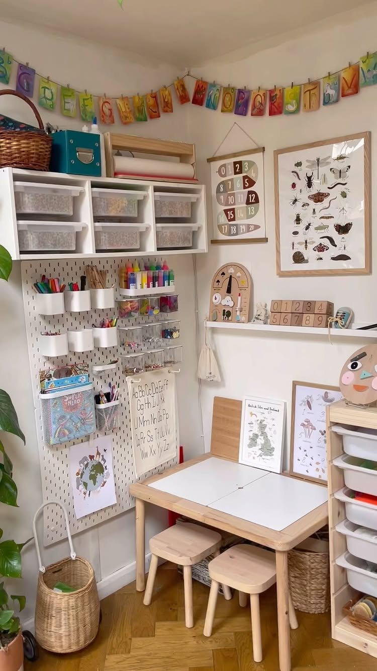 A white pegboard organizer filled with colorful art supplies above a small wooden child's table.