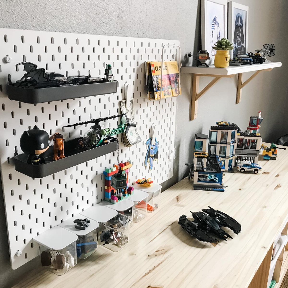 7 Toy Organization Ideas for Playrooms and Living Spaces 7 Lego models and vehicles displayed on a wooden table and white pegboard shelving.