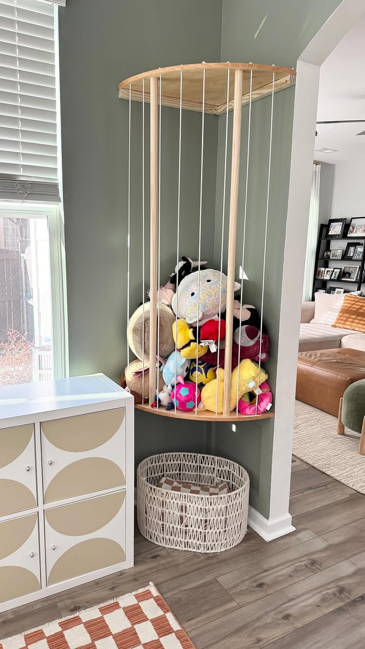 7 Toy Organization Ideas for Playrooms and Living Spaces 5 A wooden wall-mounted shelf unit holding colorful stuffed animals against a green wall.