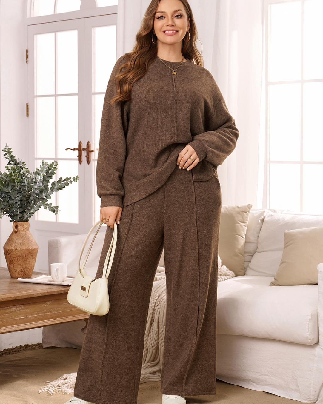 A woman posing in a matching brown knit sweater and wide-leg trousers set.