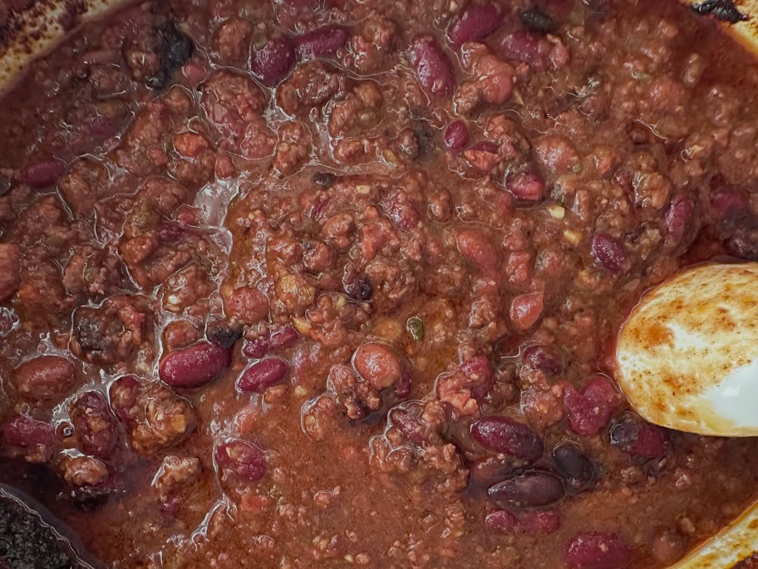 Hearty chili with ground meat and red kidney beans simmering in a thick tomato sauce.