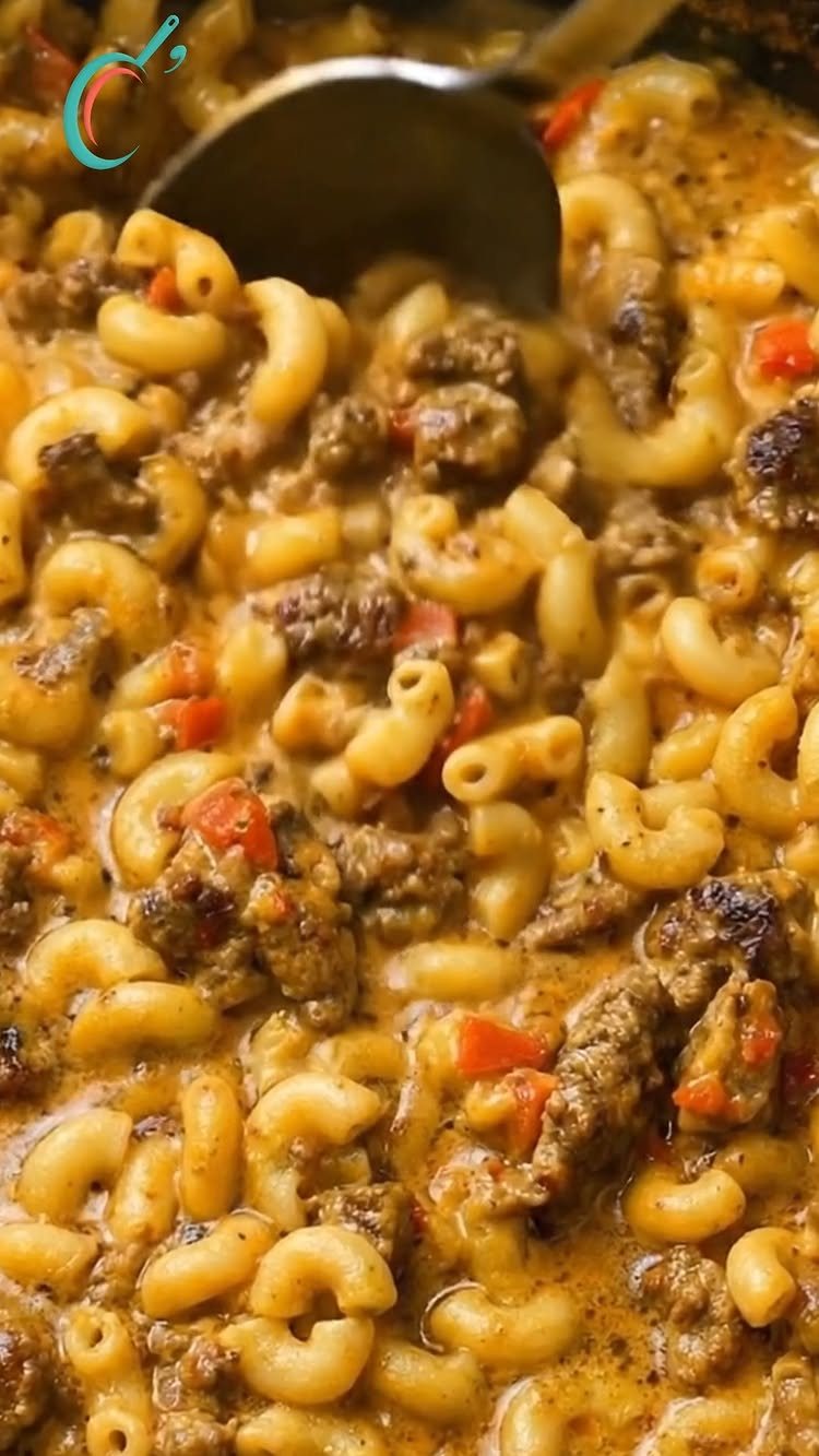 Macaroni pasta mixed with ground beef and creamy sauce in a slow cooker.