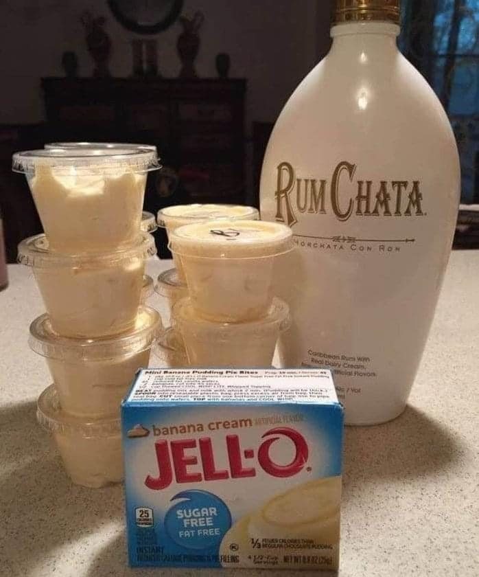 Small plastic containers of creamy pudding next to RumChata and Jell-O banana cream pudding mix.
