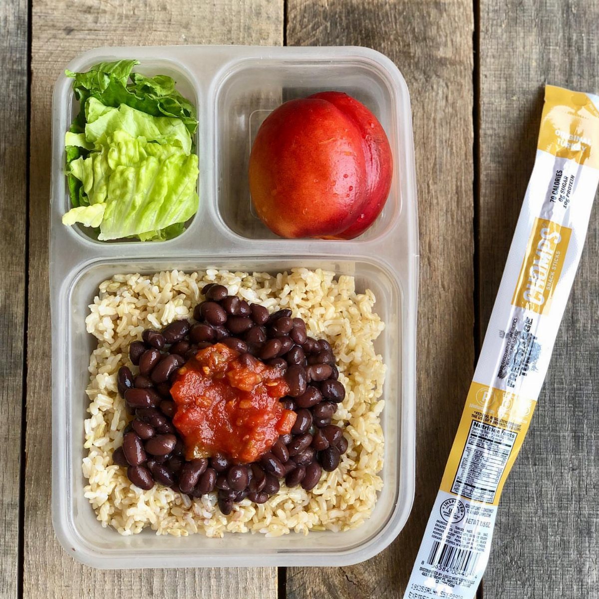 19 School Lunch Ideas for Real Mornings 6 Brown rice topped with black beans and salsa, served with lettuce and a peach in a container.