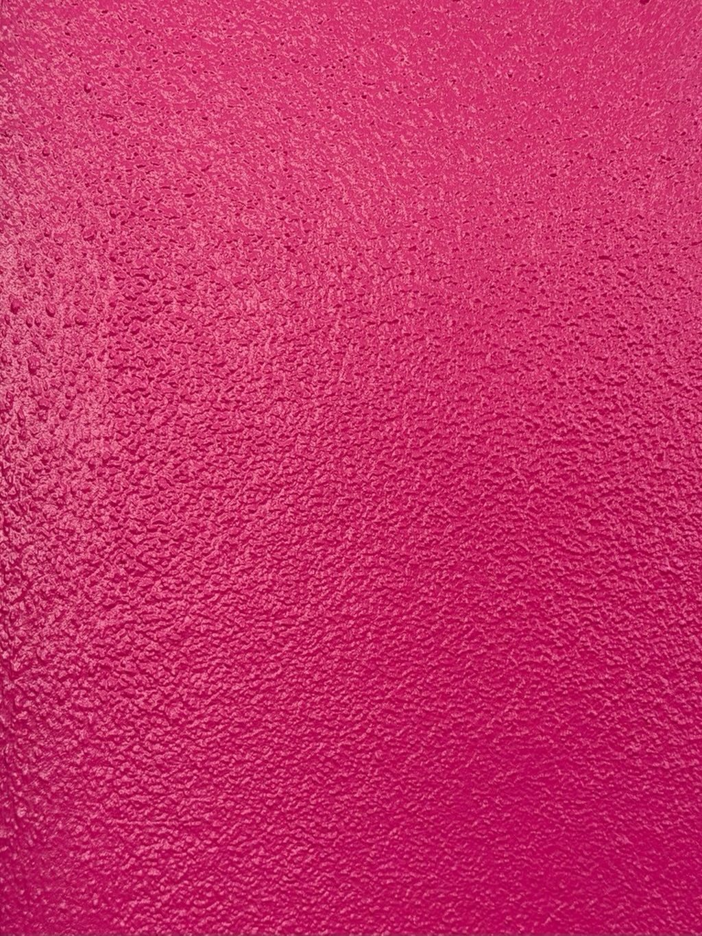 9 Hot Pink Background Ideas for Phones and Walls 1 A textured, solid hot pink surface with a granular, unevenly painted finish.