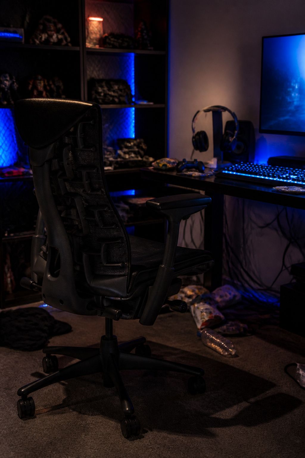 Cluttered workspace featuring a Herman Miller Embody chair and office supplies