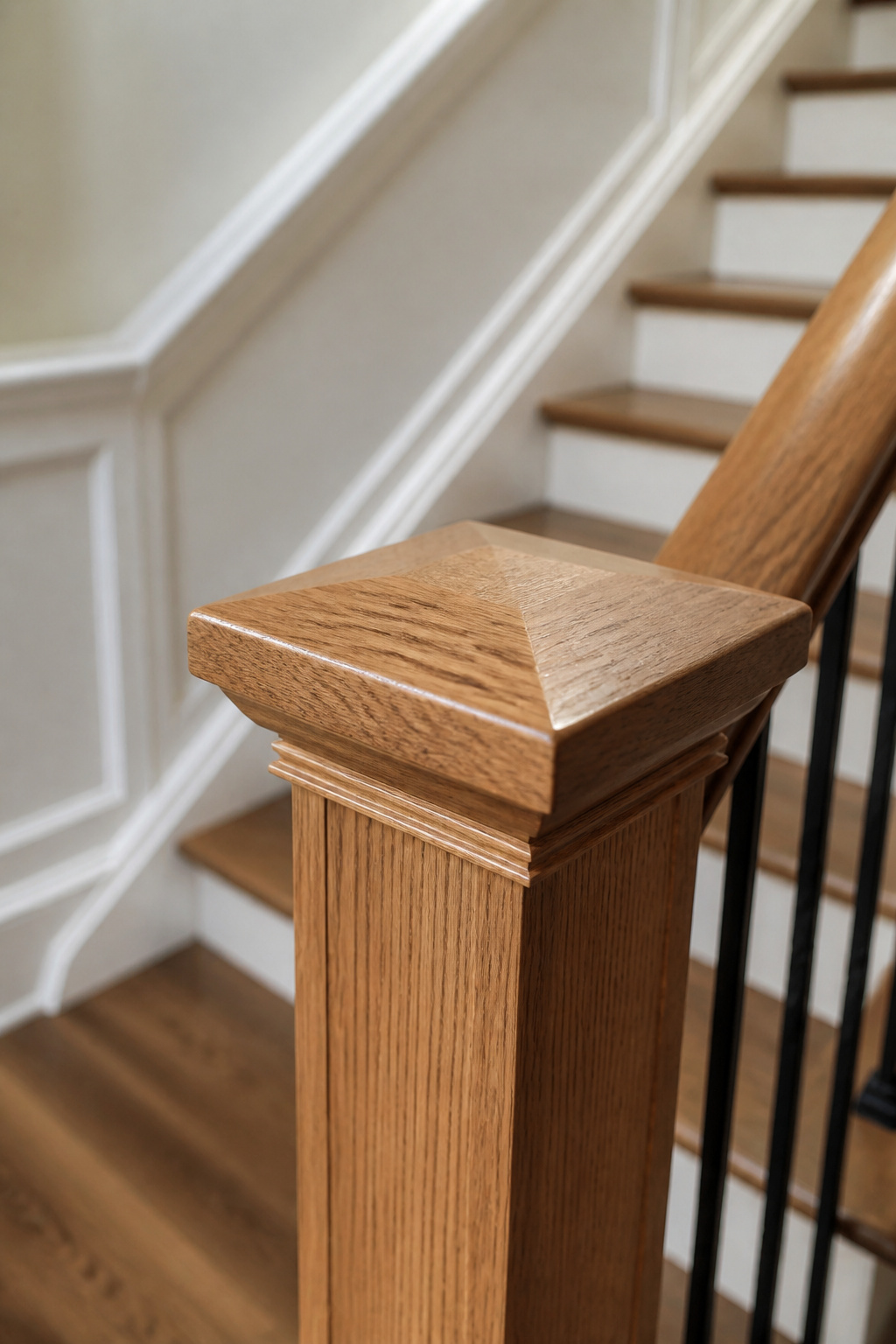 A newel post cap that sits proud of the post on a staircase.