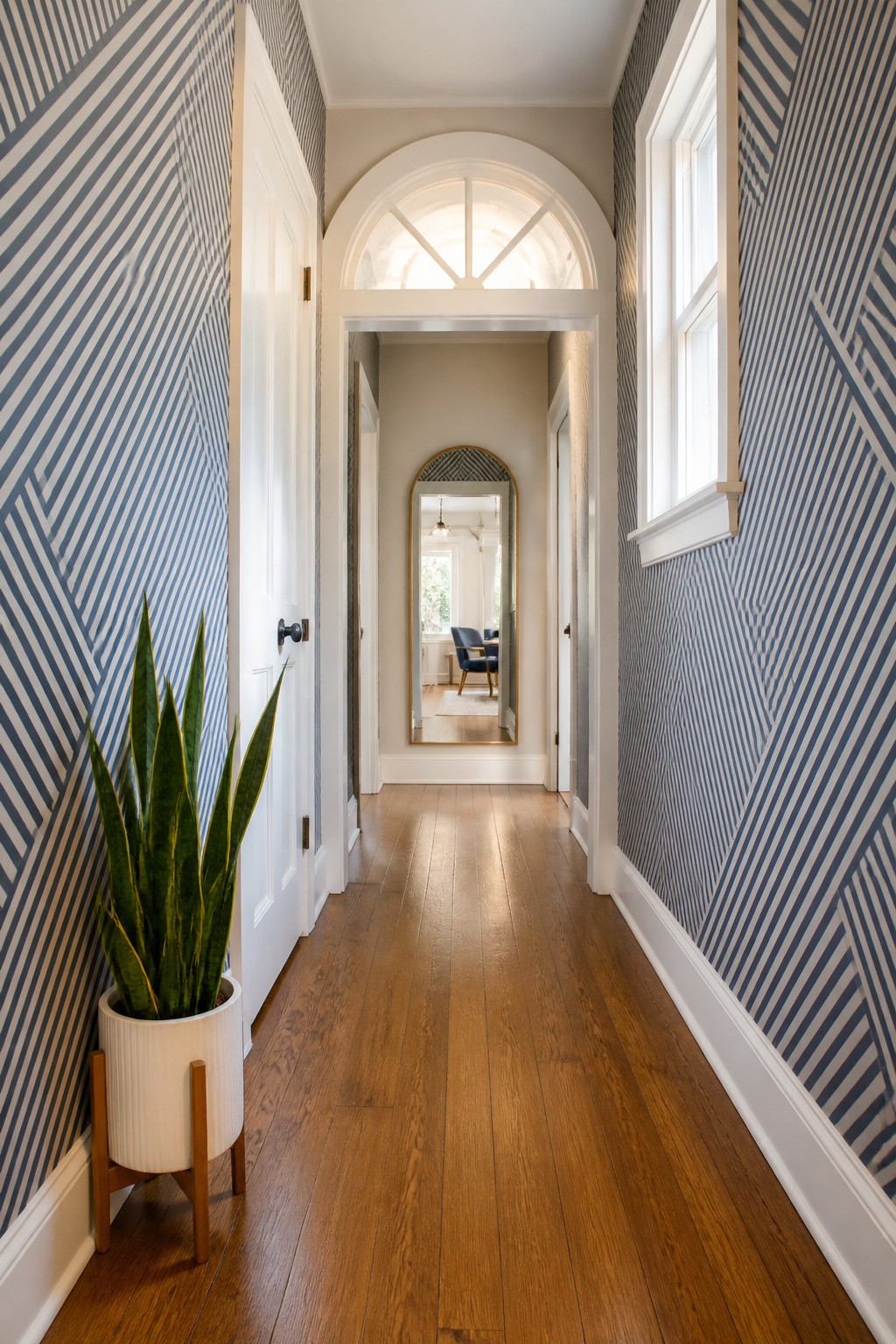 A hallway featuring navy and white diagonal striped geometric wallpaper.