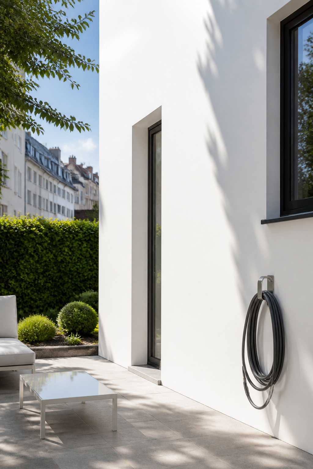 A white facade with a self-cleaning treatment reflecting sunlight.