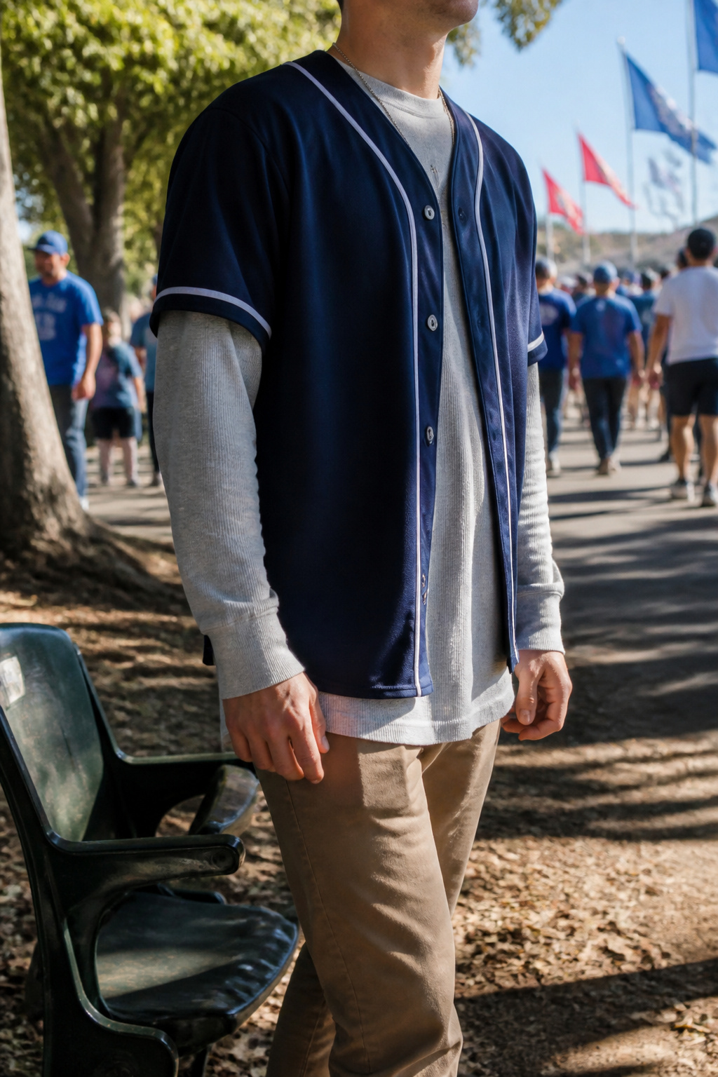 Model in a layered jersey over a long-sleeve tee, highlighting sleeve length.