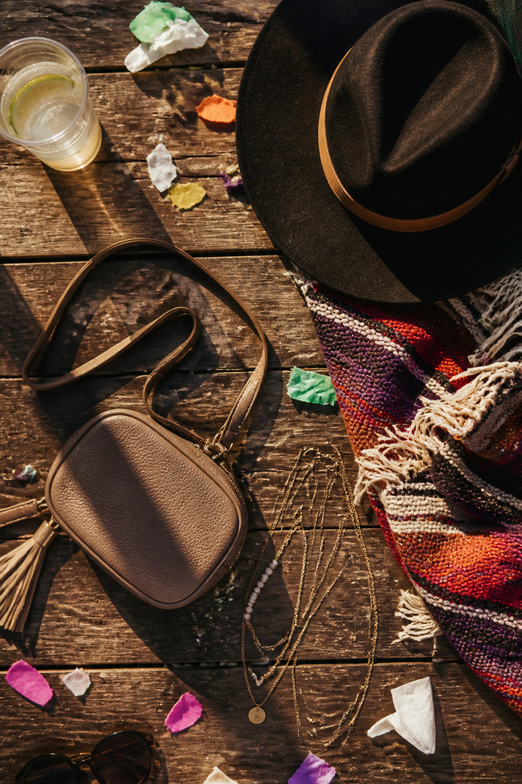 A small crossbody bag and layered jewelry for concert accessories.