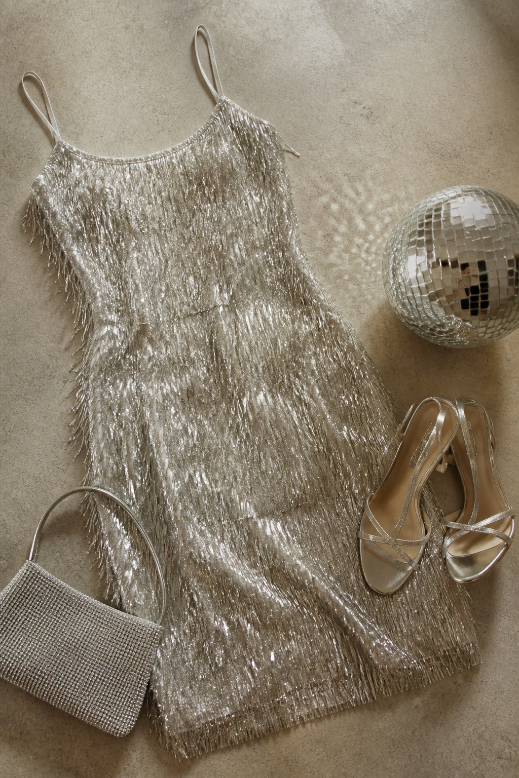 A mini dress with fringe details displayed in natural light.