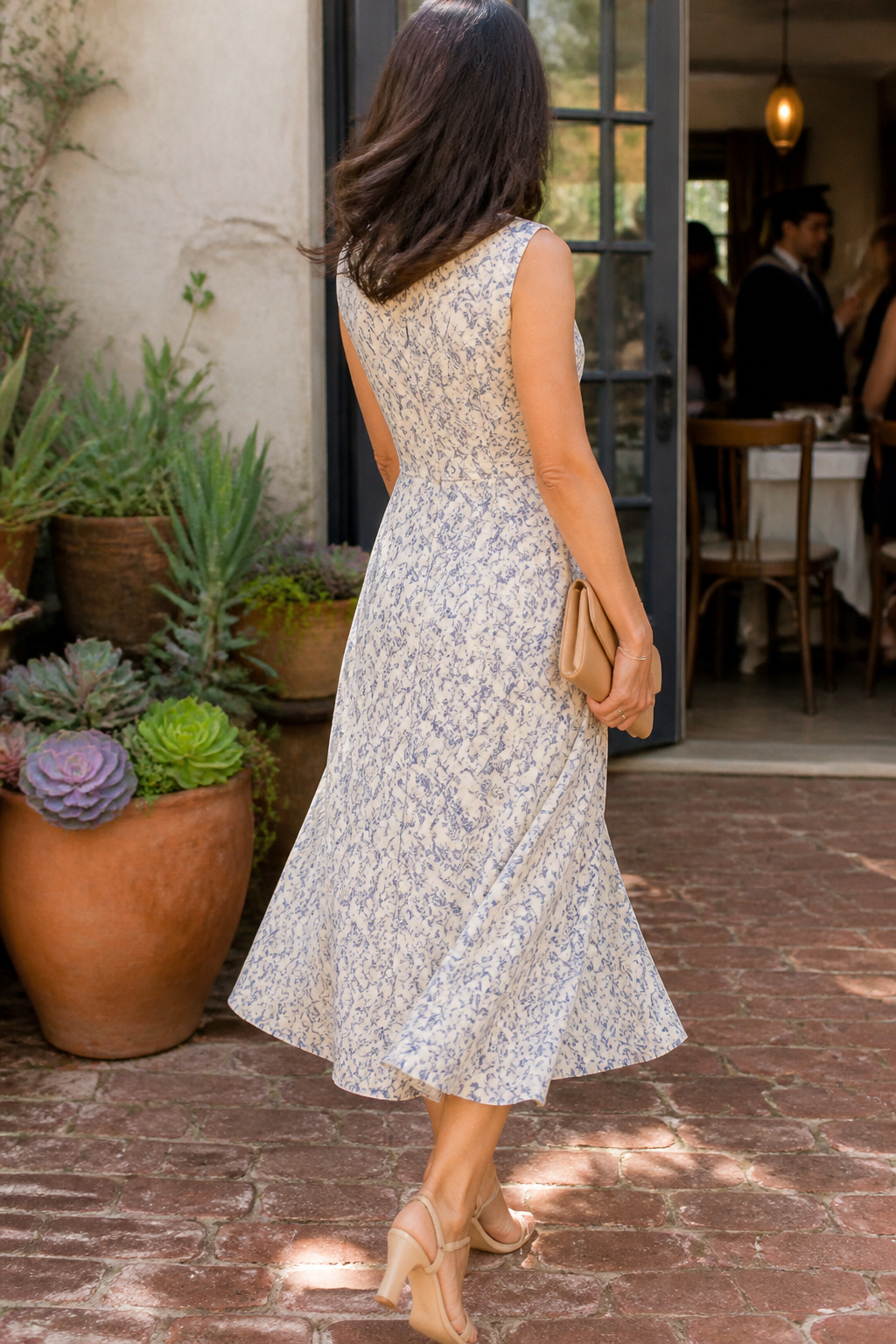 A woman in the Banana Republic Poplin Midi Dress against a colorful patio.