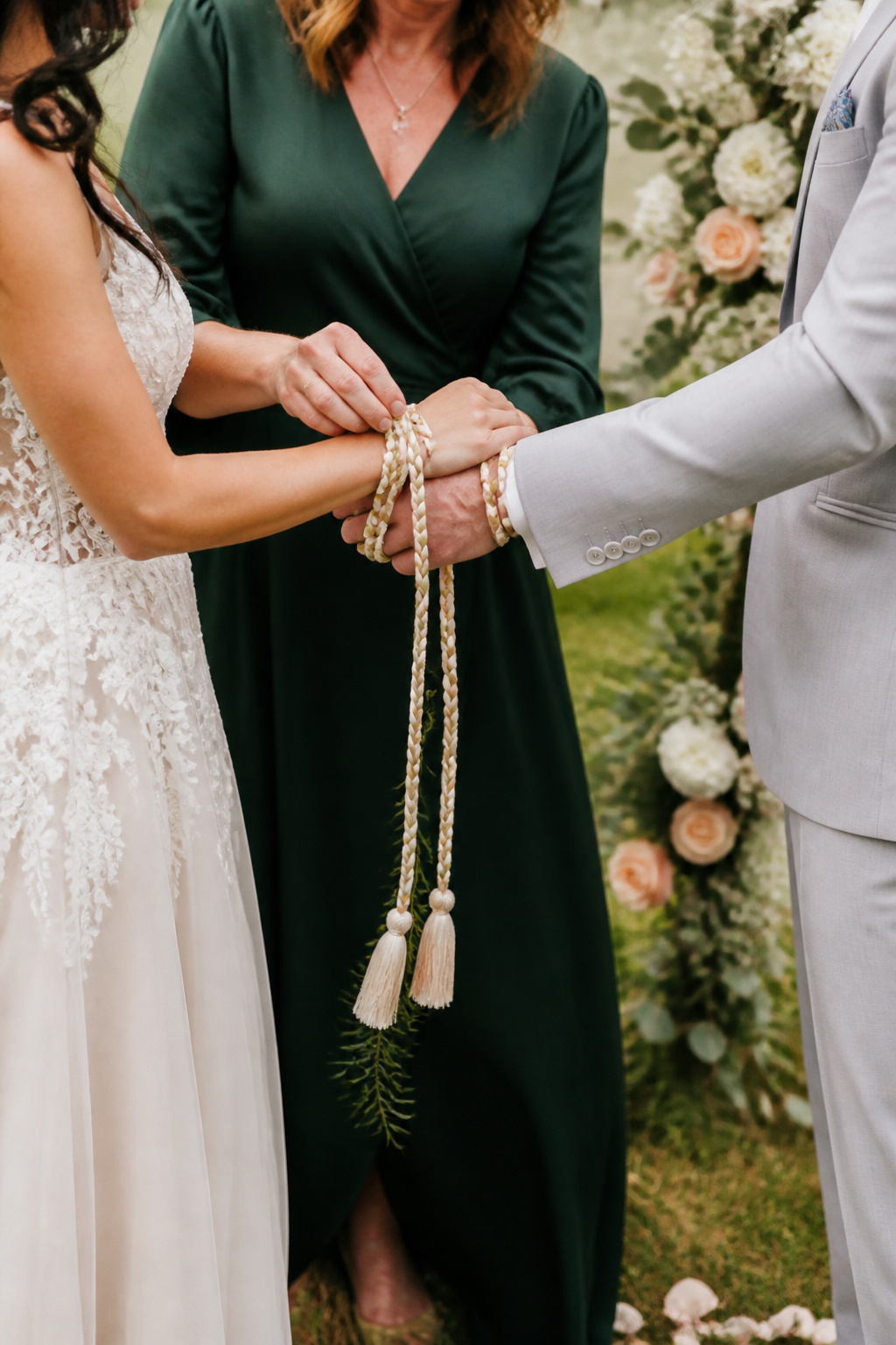 Officiant loosening the knot while discussing commitment with the couple.