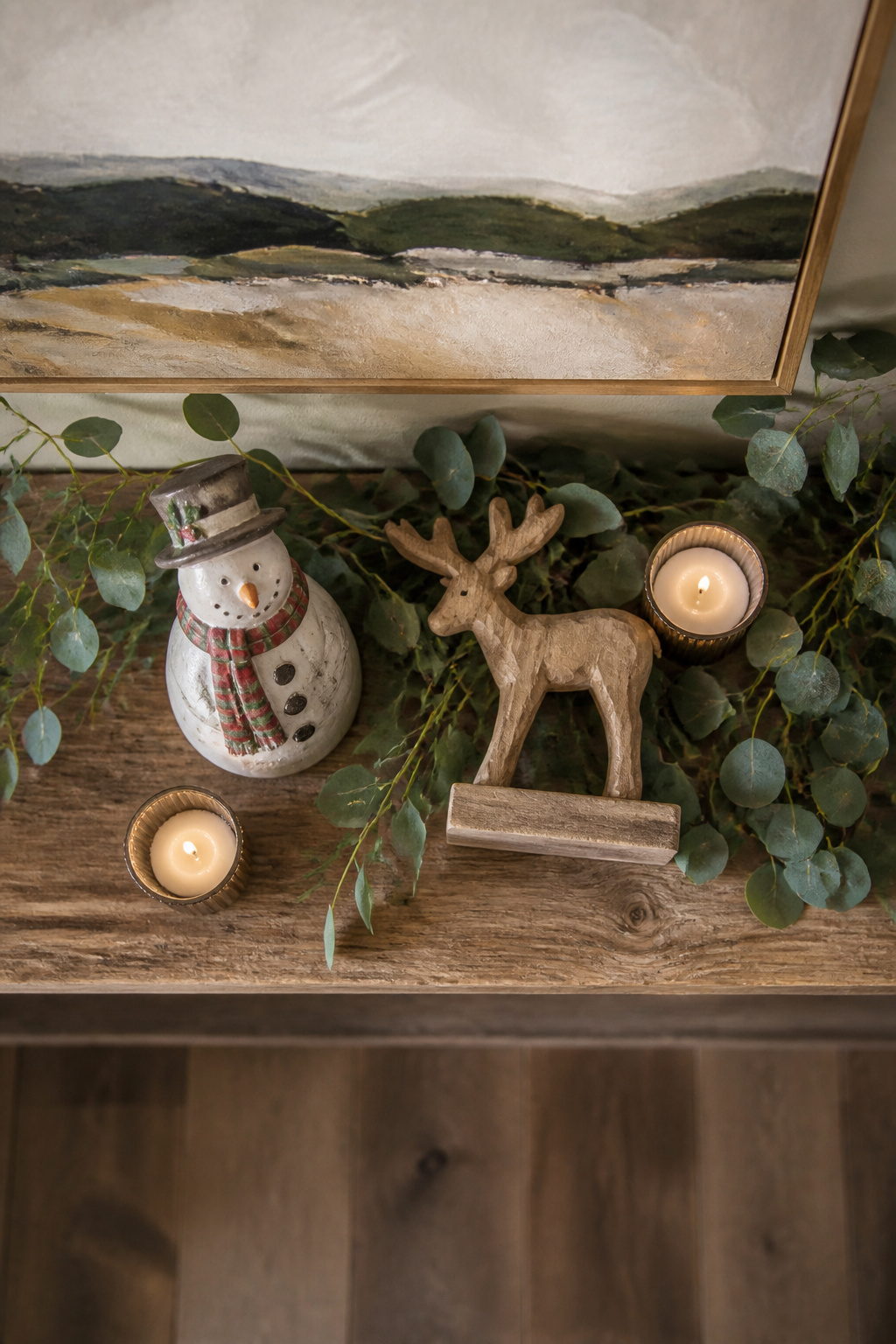 A selection of decorative ornaments and figurines on a mantel.