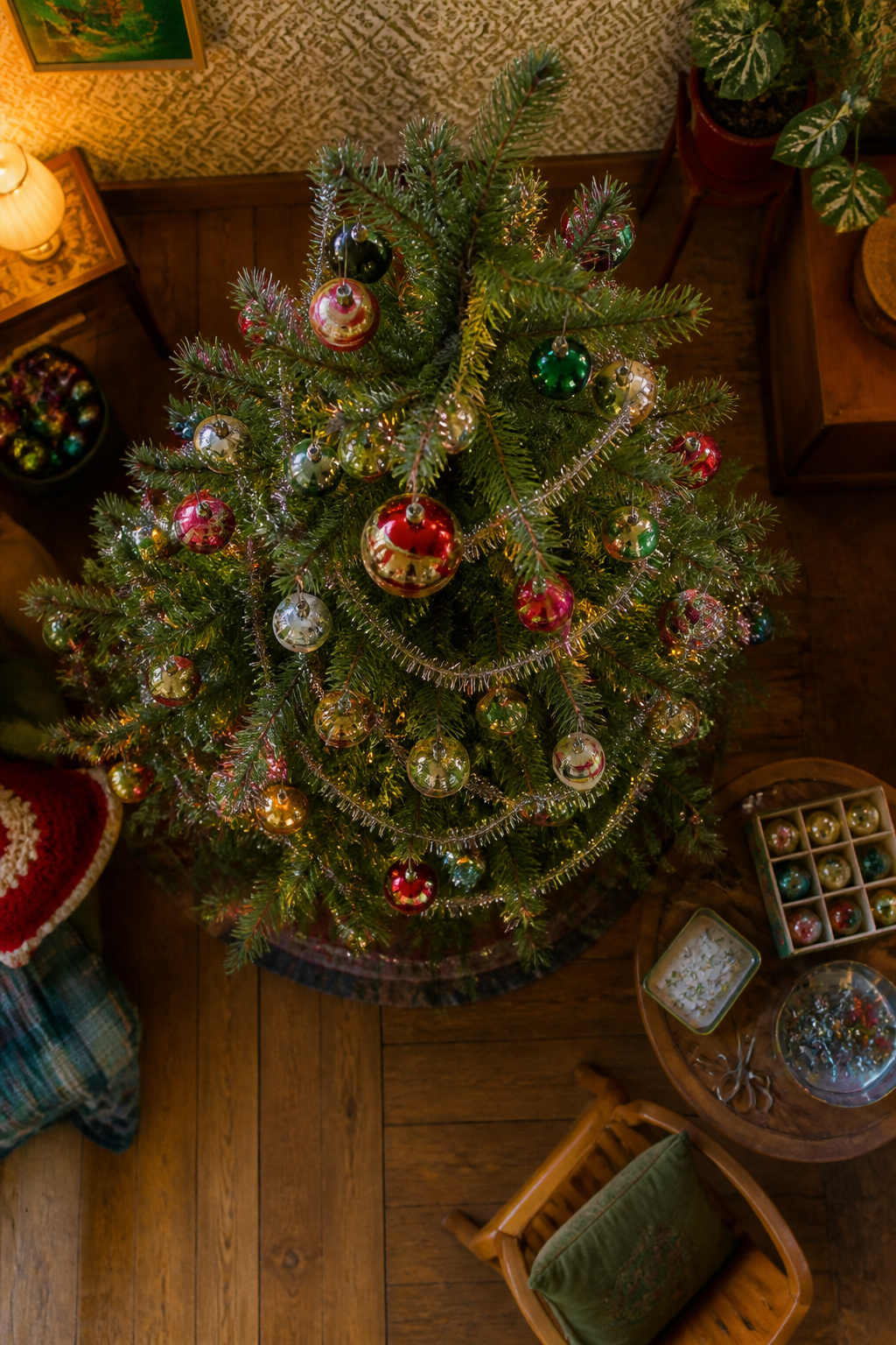 Traditional Christmas tree decorated with tinsel and glass ornaments.