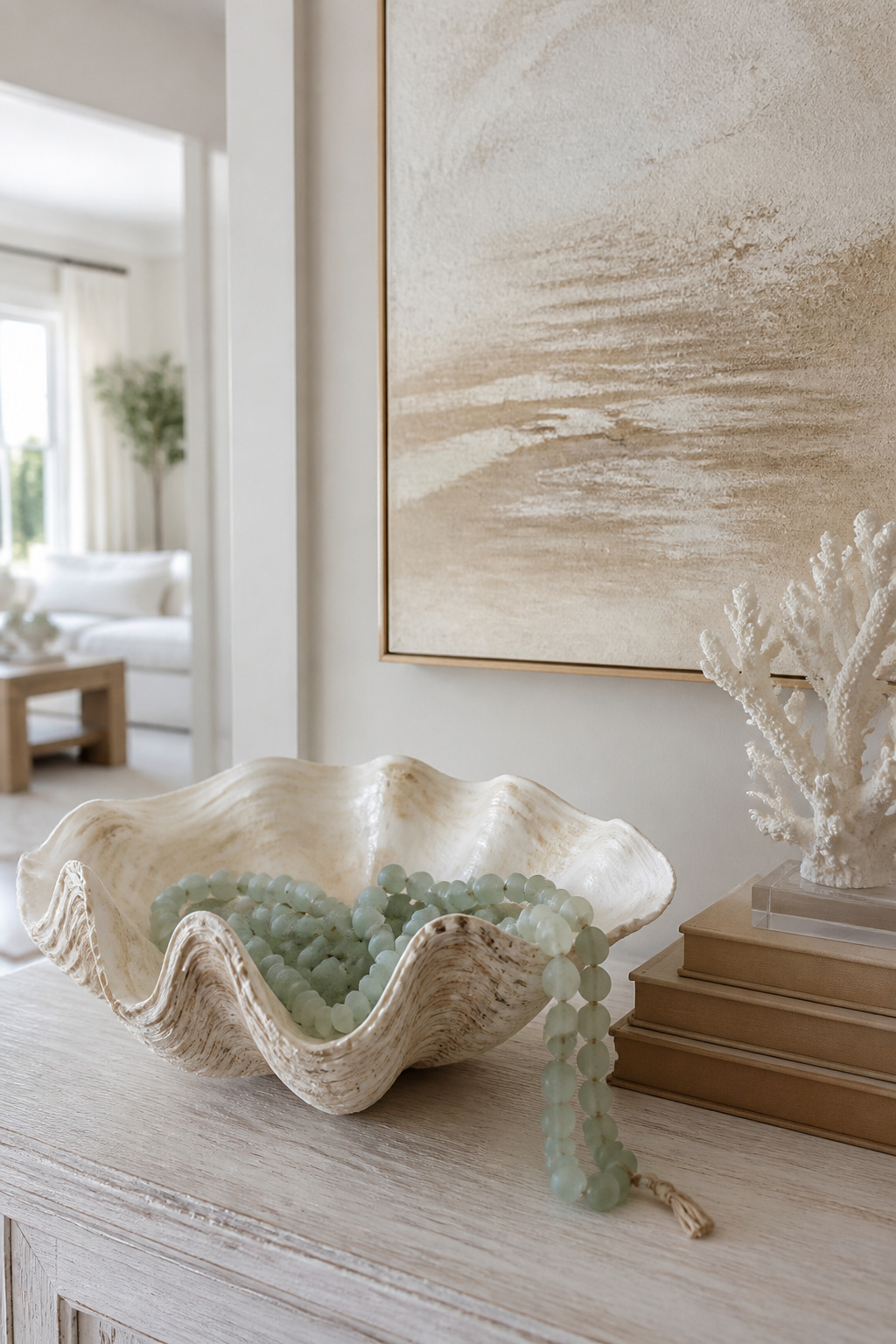 Decorative clamshell on a console table with sea-glass beads.