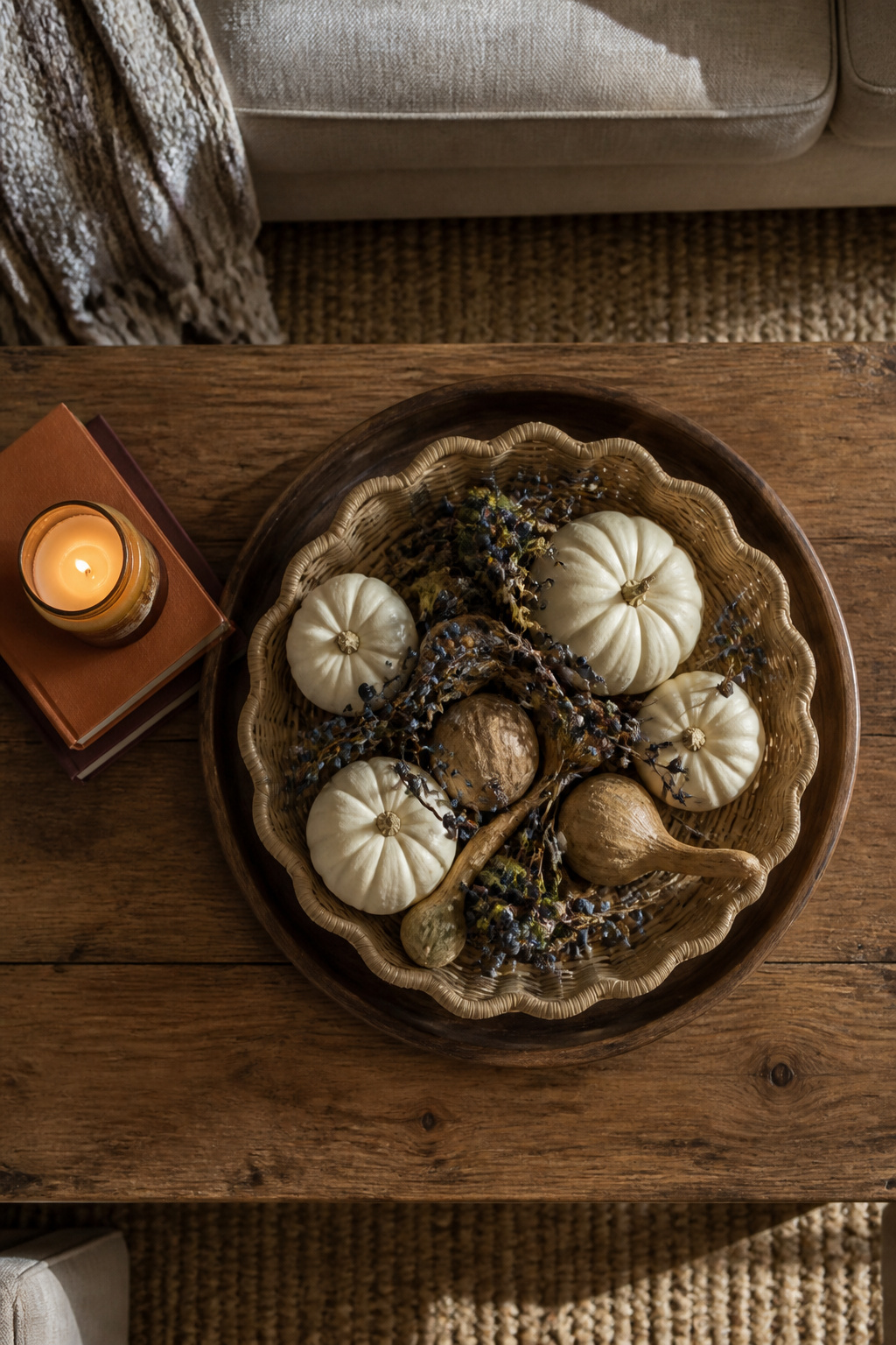 Coffee table decorated with a rattan tray and seasonal decor.