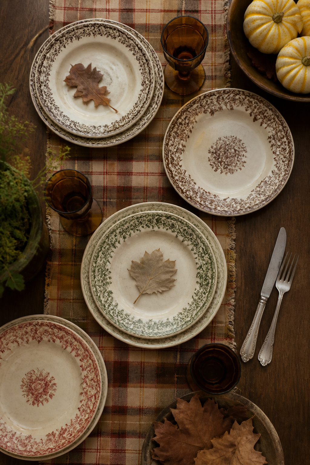7 Rustic Thanksgiving Table Ideas: Natural, Vintage & Thrifted for 2026 3 Antique plates in warm colors on a rustic Thanksgiving table.