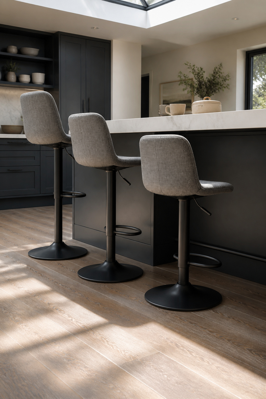 Adjustable height upholstered stools with a gas-lift mechanism.