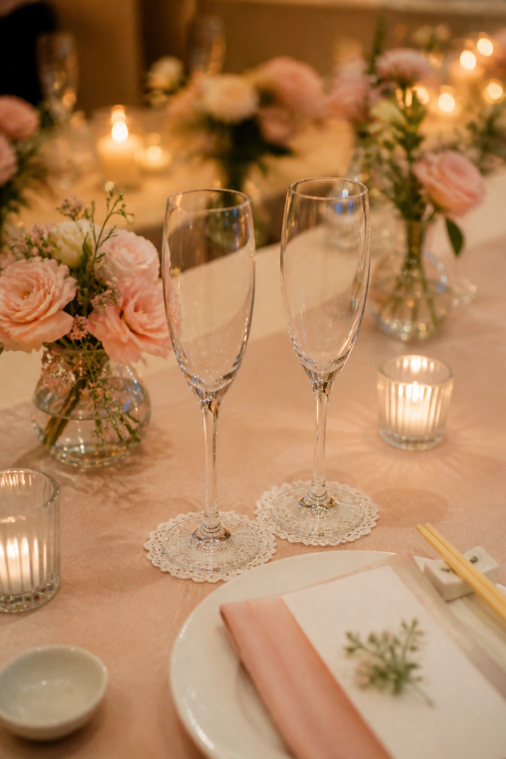 A set of personalized champagne flutes on a bridal table.