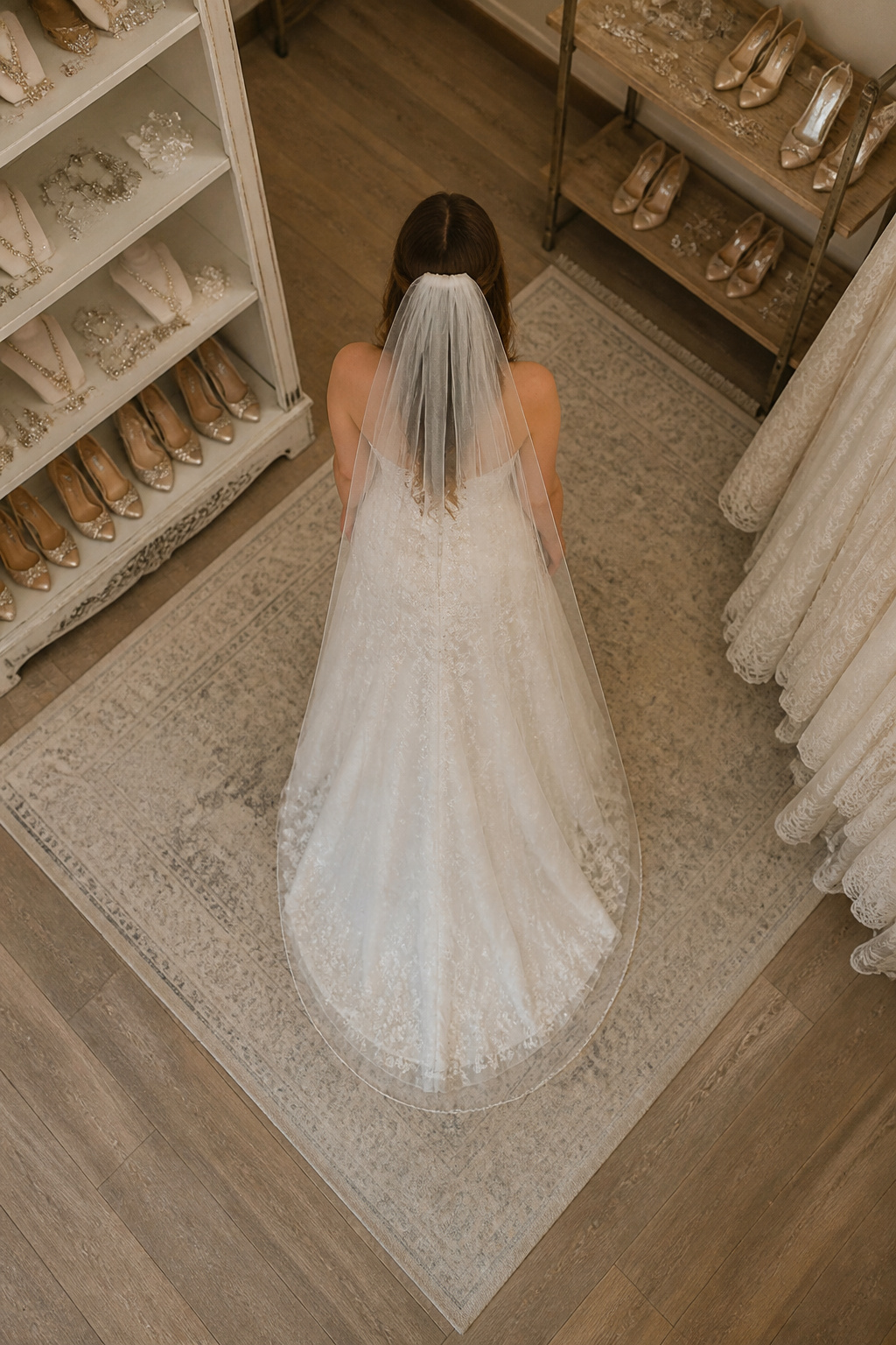 A model wearing an A-line gown with a fingertip veil.