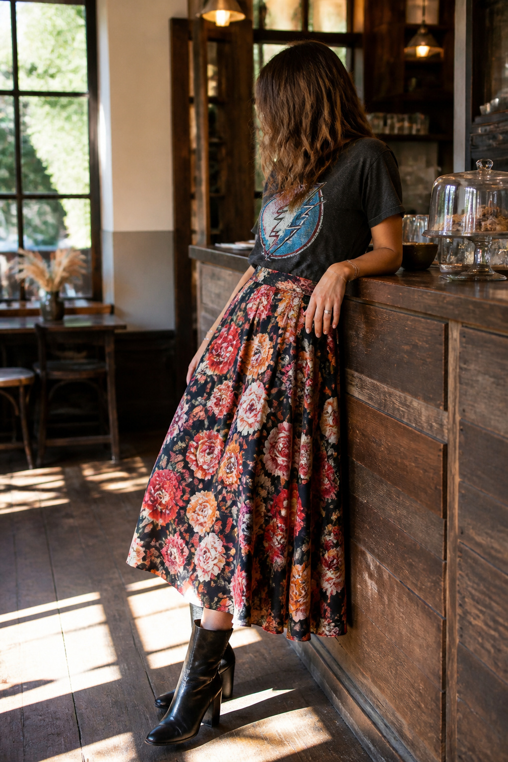 10 Fall Skirt Outfit Ideas for 2026 3 Model wearing a floral midi skirt and a graphic t-shirt.
