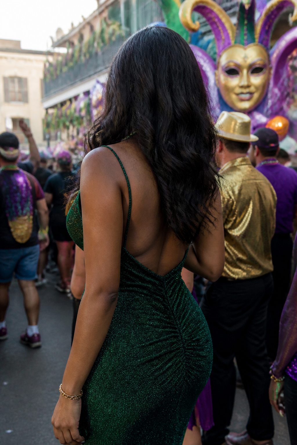 Person wearing a green dress with purple lipstick and gold bracelet.