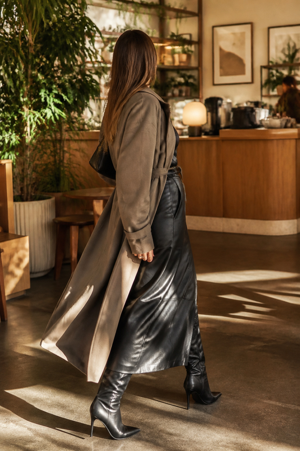 27 Winter Outfit Ideas for Women: 2026 Style Guide 2 Woman in a faux leather maxi skirt and oversized trench coat.