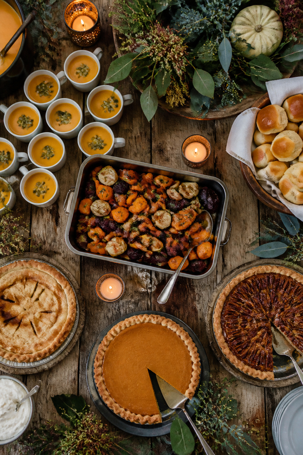 7 Autumn Wedding Ideas for Colors, Decor, Venues & More 5 Small cups of pumpkin soup and colorful roasted root vegetables on a table.
