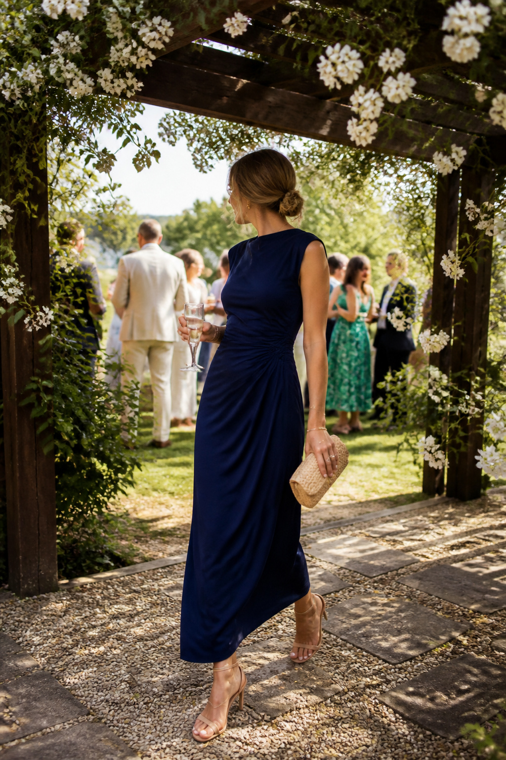 Model in Anais Marine Stretch dress under a decorative arbor.