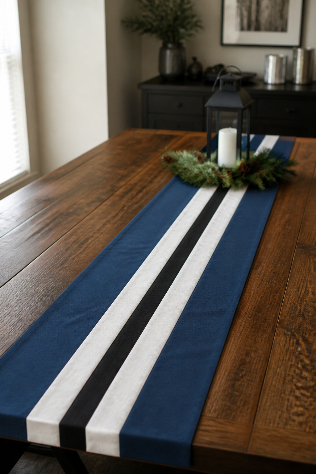 A table runner made of blue, white, and black fabric strips.