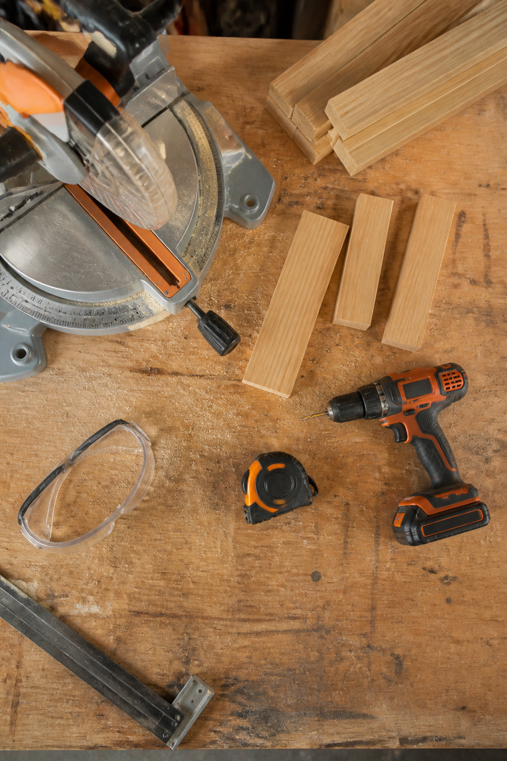 A collection of tools including a saw, drill, and measuring tape.