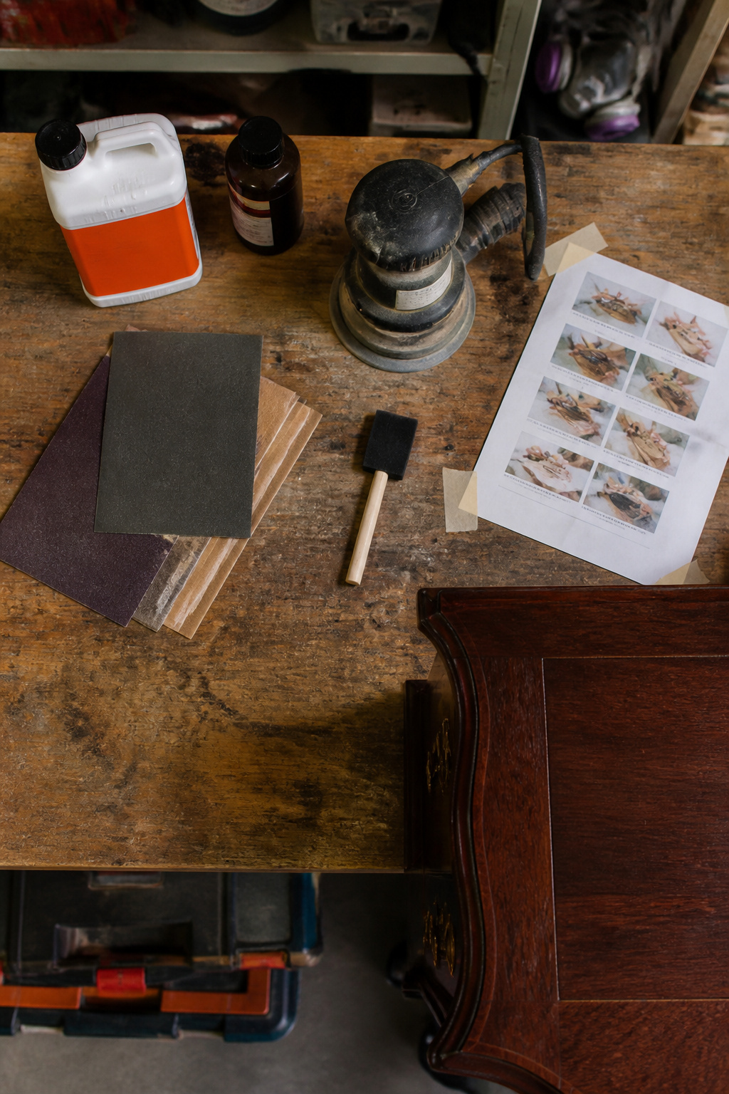 Supplies for refinishing a wood desk neatly arranged.