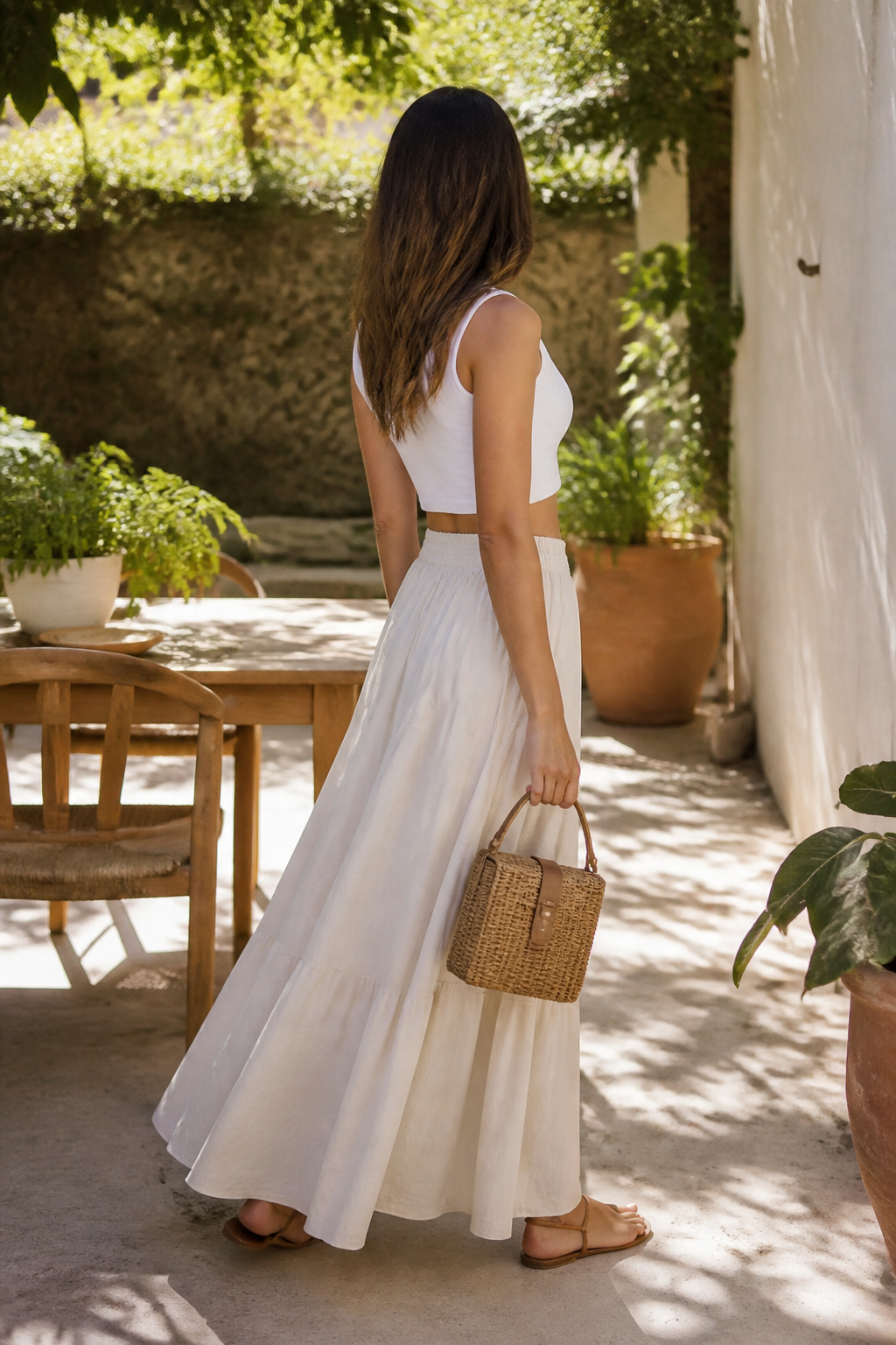 A crop top and maxi skirt outfit displayed outdoors.