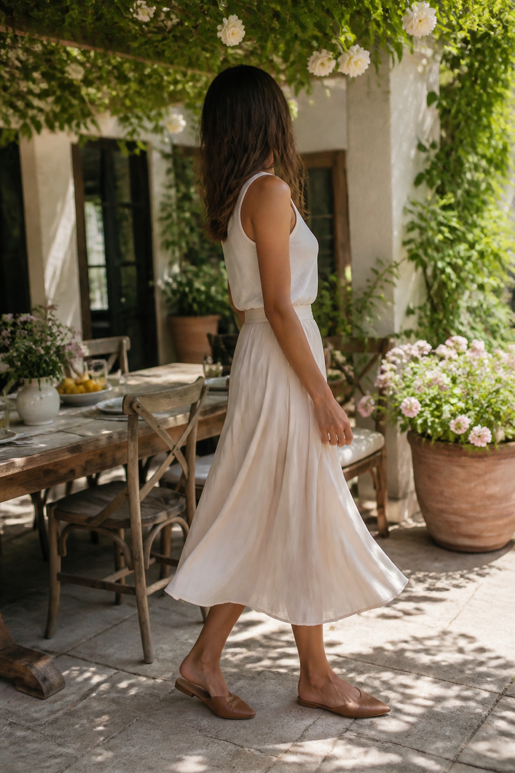 A midi skirt paired with a simple tank top in a garden patio.
