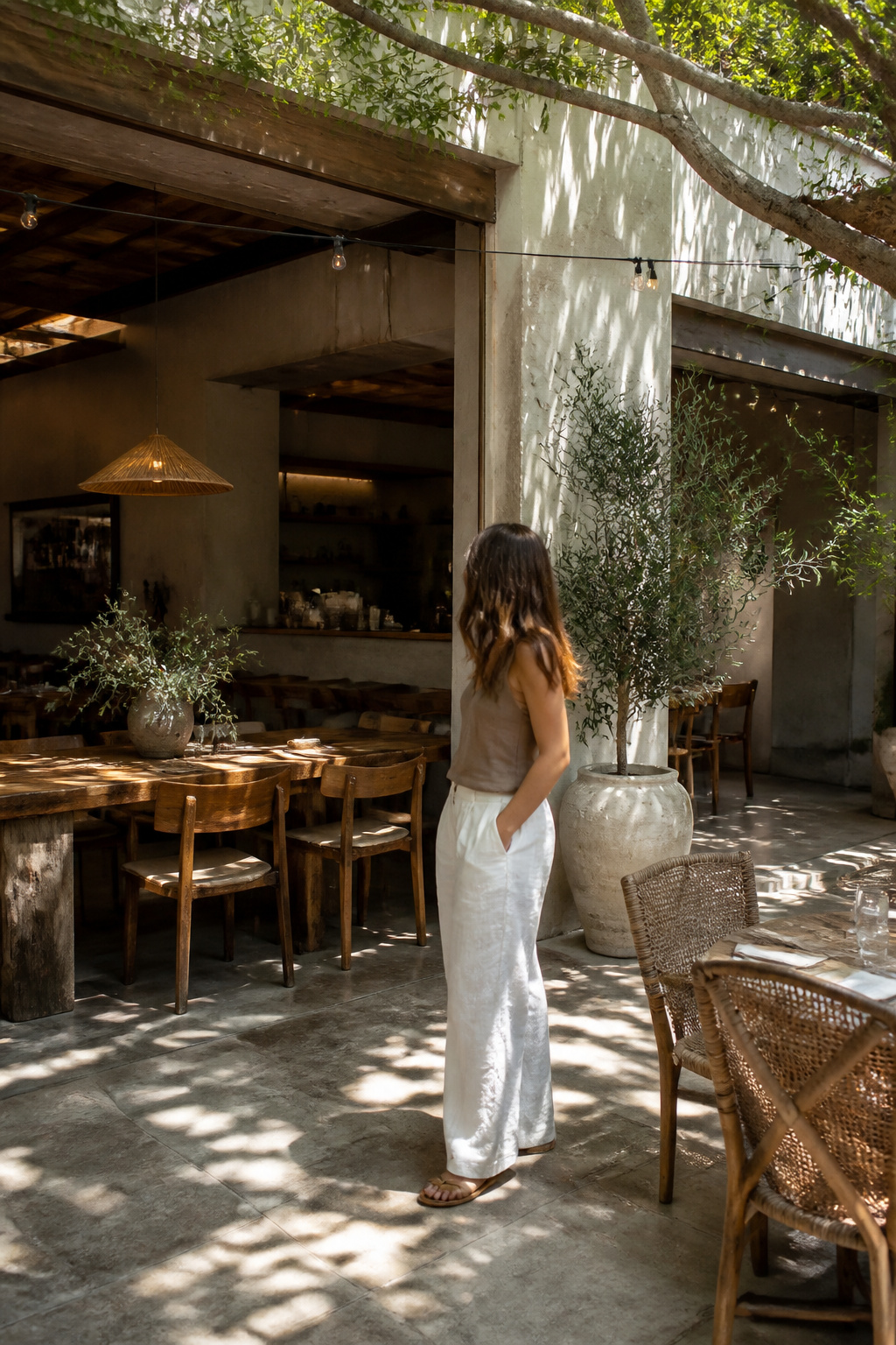 A casual outfit featuring white linen pants and a tank top.