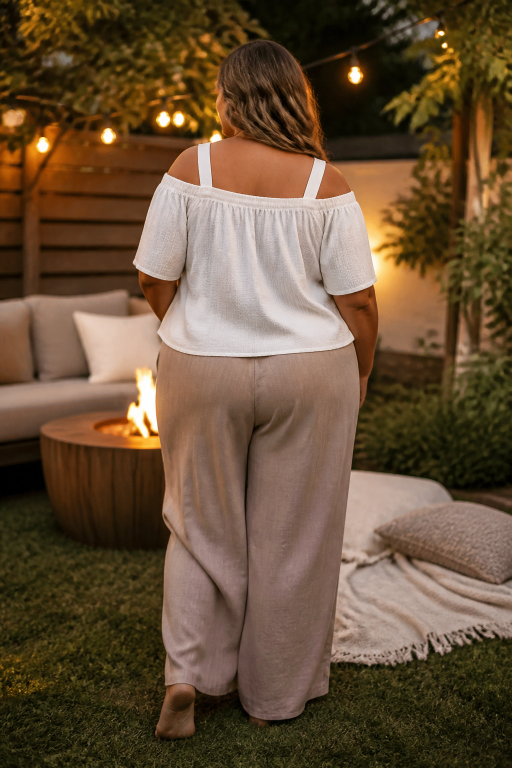 A light cotton off-shoulder top with wide straps and linen pants.