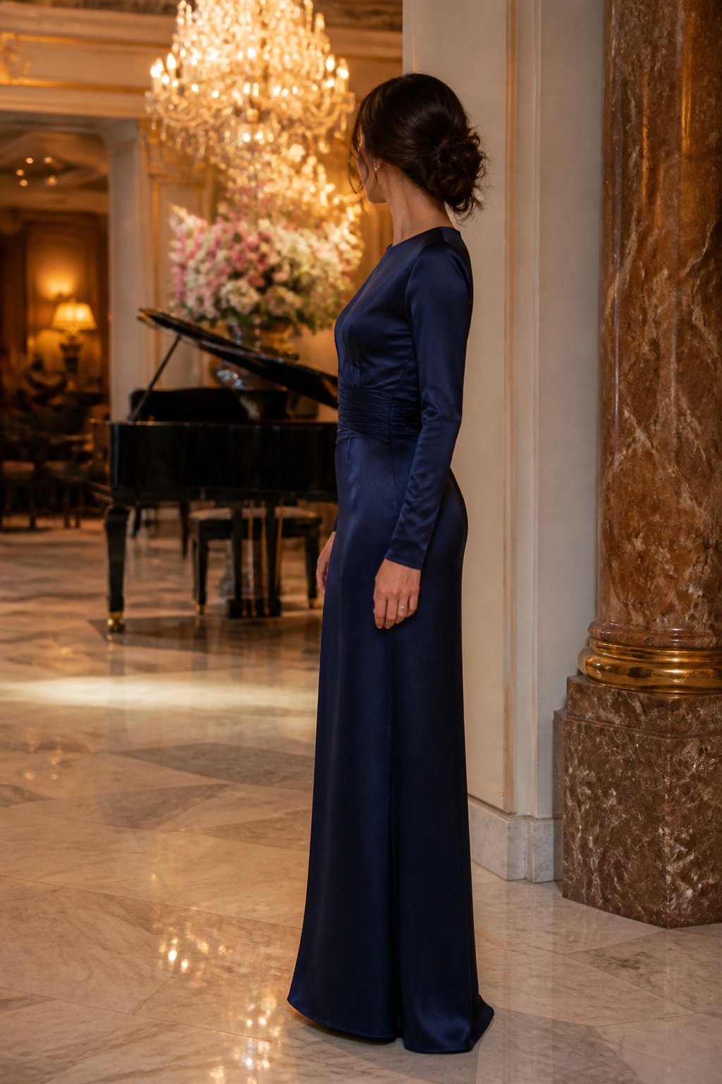 Long sleeve satin column dress displayed in a formal setting.