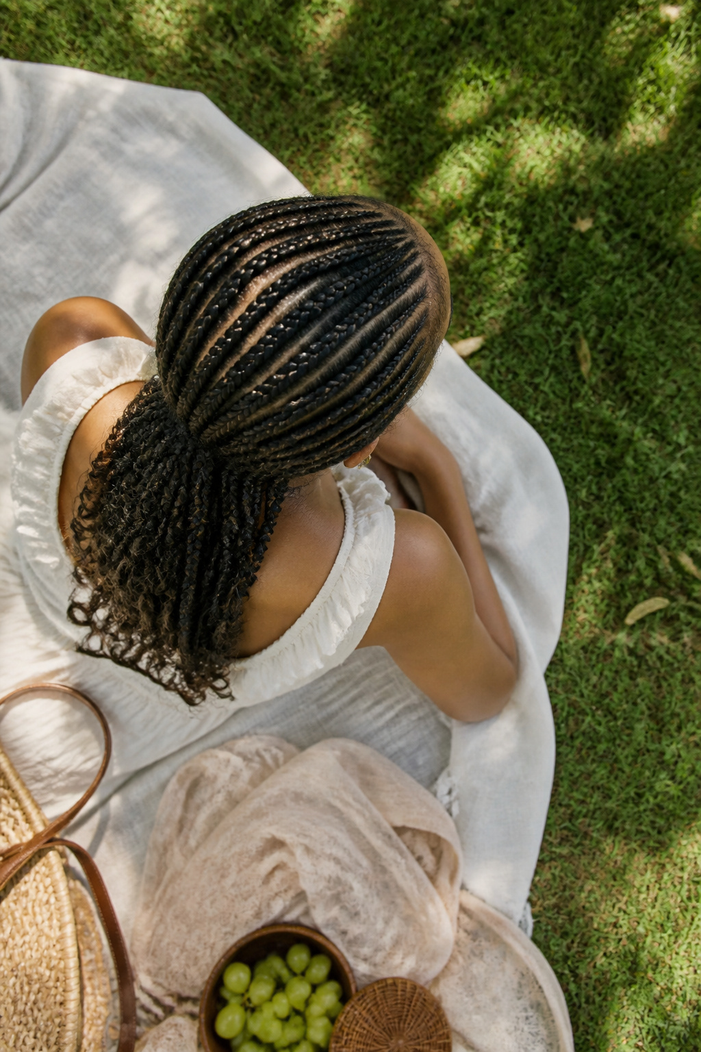 A model with cornrows styled neatly against the scalp, ready for summer.