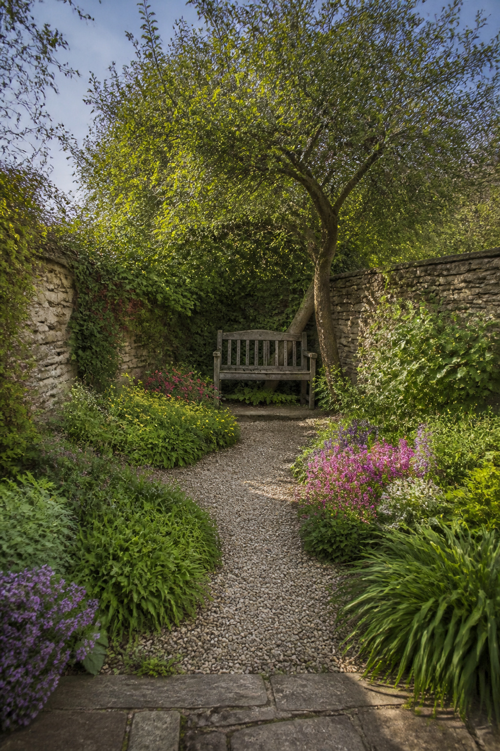 A small bench placed in a garden.